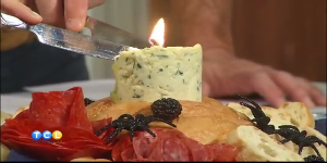 A beautifully arranged edible butter candle with herbs and bread